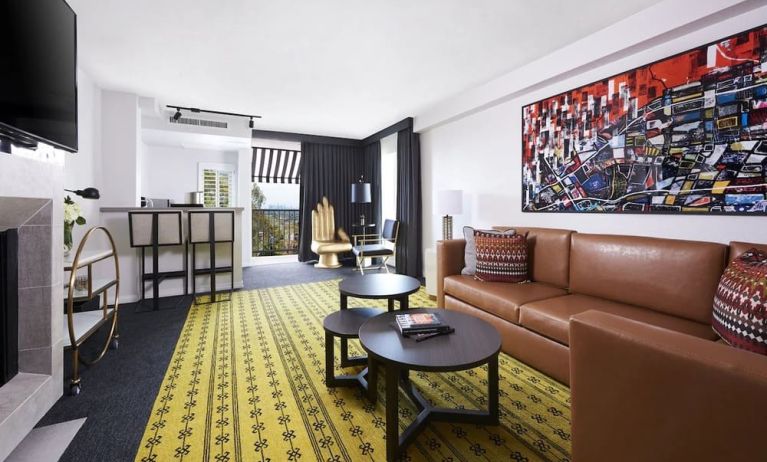 Day use suite with living area, fireplace, balcony and in-room kitchen at Montrose At Beverly Hills.