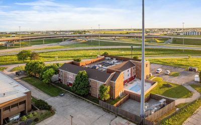 Property exterior at Coratel Plus Suites Wichita West Airport.