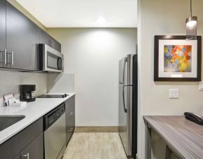 Kitchen at Homewood Suites By Hilton Orlando Theme Parks.