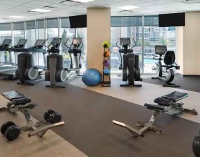 Fully equipped fitness center with treadmills and weights at the Hilton Vancouver Downtown.