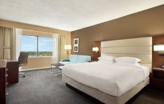 Oversized king room with sofa bed, dining and living Area at the DoubleTree by Hilton Orlando Downtown.