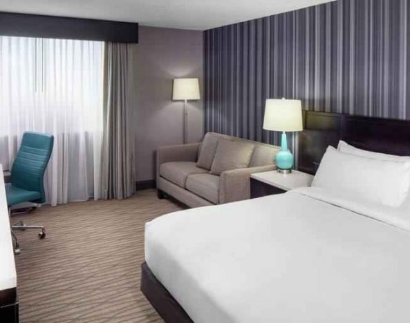 Spacious king size bed room with desk, tv and bath at the DoubleTree by Hilton Cleveland Westlake.