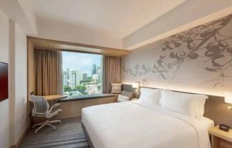 King size bed in a deluxe room with great city view at the Hilton Garden Inn Singapore Serangoon.