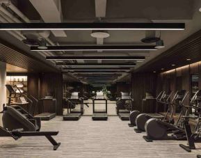 Stylish fitness center with treadmills and excercise bikes at the Hilton Singapore Orchard.