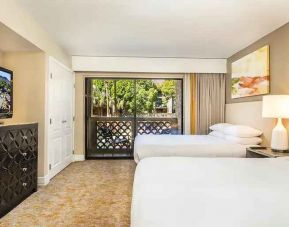 Bright and comfortable bedroom with 2 queen size beds, TV screen and window at the Hilton Phoenix Resort at the Peak