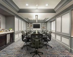 Classy conference room with crown molding, presentor flatscreen TV and seating for 10.