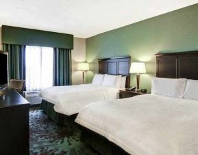 Day use twin room with TV, work desk and window view at the Hampton Inn by Hilton Toronto Airport Corporate Centre.