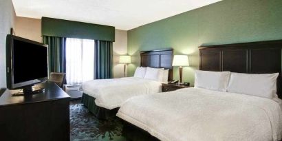 Day use twin room with TV, work desk and window view at the Hampton Inn by Hilton Toronto Airport Corporate Centre.