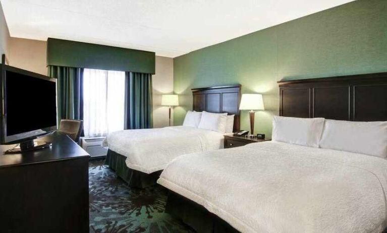 Day use twin room with TV, work desk and window view at the Hampton Inn by Hilton Toronto Airport Corporate Centre.