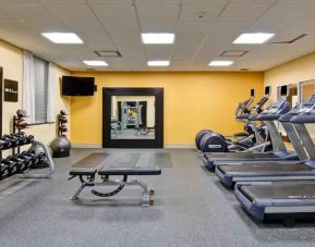 Fully equipped fitness center with treadmills and weights at the Hampton Inn by Hilton Toronto Airport Corporate Centre.