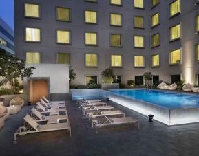 Relaxing outdoor pool area at the Hilton Garden Inn Dubai Mall of the Emirates.