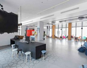 Spacious working station with desks and computers at the Hampton by Hilton Dubai Al Seef.