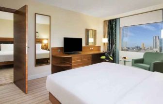 Comfortable queen room with window view and working desk at the Hilton Ras Al Khaimah Beach Resort.