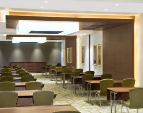 Large meeting room and workspace with multiple chairs and desks at the Hilton Garden Inn Dubai Al Muraqabat