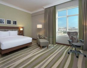 King bedroom with king bed, desk, and ergonomic chair at the Hilton Garden Inn Dubai Al Muraqabat
