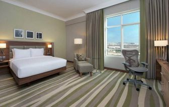 King bedroom with king bed, desk, and ergonomic chair at the Hilton Garden Inn Dubai Al Muraqabat