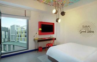 Comfortable room with window and TV screen at the Hampton by Hilton Dubai Al Seef.