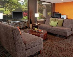 Comfortable lobby, business area, and coworking space at DoubleTree Suites by Hilton Hotel Dayton - Miamisburg.