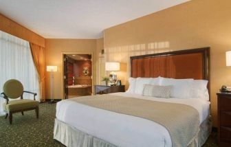 Spacious 2 bedroom suite with a king size bed, desk, tv, and bath at the Embassy Suites by Hilton Hampton Convention Center
