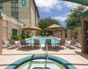 Beauitful outdoor pool with pool chairs and small jacuzzi at the Embassy Suites by Hilton Tampa USF