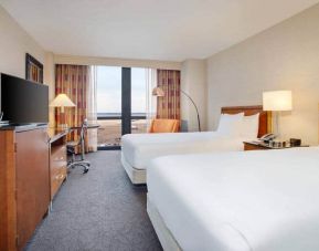 Spacious room with two queen beds,soundproof windows, chairs at the Hilton Chicago O'Hare Airport