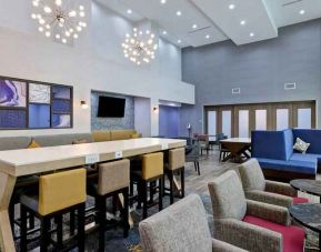 Workspace with chairs and sofas at the Hampton Inn & Suites Houston East Beltway 8.