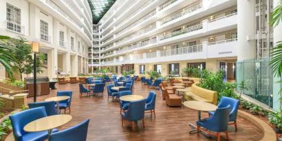 Beautiful and bright outdoor workspace with sofas and chairs at the Embassy Suites by Hilton Alexandria-Old Town.