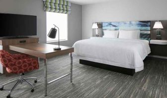 delux king-sized bed with work desk at Hampton Inn Wichita Northwest.