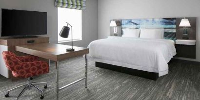 delux king-sized bed with work desk at Hampton Inn Wichita Northwest.