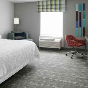 spacious king-sized room with TV and workspace at Hampton Inn Wichita Northwest.