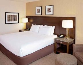 Comfortable king-sized bed with work area at DoubleTree by Hilton Boston Bayside.