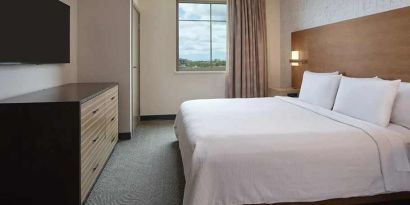 comfortable king bed at Embassy Suites by Hilton Oahu Kapolei.