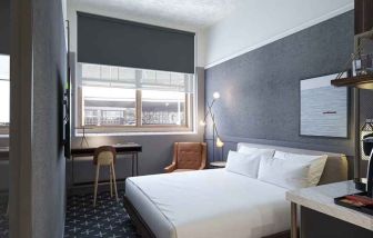 king bed with desk and all amenities at The Slate Denver, Tapestry Collection by Hilton.