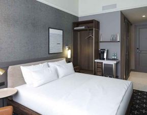 king bed with desk and all amenities at The Slate Denver, Tapestry Collection by Hilton.