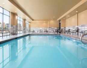 brigh-lit indoor pool with seating area at Hampton Inn Salt Lake City Cottonwood.