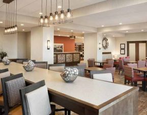 bright-lit lobby and coworking space with natural light and a variety of seating at Hampton Inn Salt Lake City Cottonwood.