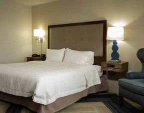 cosy king bedroom with lounge furniture at Hampton Inn & Suites La Crosse Downtown, WI.