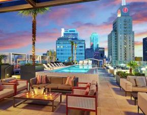 Stunning rooftop with pool and seating area perfect as workspace at the Statler Dallas, Curio Collection by Hilton.