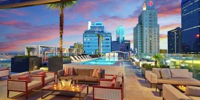Stunning rooftop with pool and seating area perfect as workspace at the Statler Dallas, Curio Collection by Hilton.