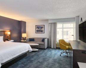 King size bed, sofa and desk in a hotel room at the Hampton Inn Washington-Downtown-Convention Center, DC.