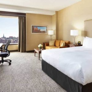 King room with 1 king bed, work desk and view of downtown at the Hilton Saint John.