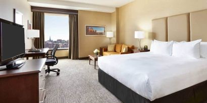King room with 1 king bed, work desk and view of downtown at the Hilton Saint John.