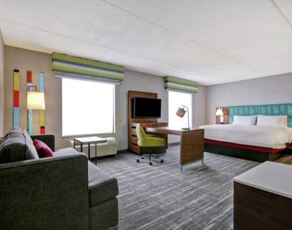 Spacious studio with 1 King bed, desk, living space and sofabed at the Hampton Inn & Suites by Hilton Guelph