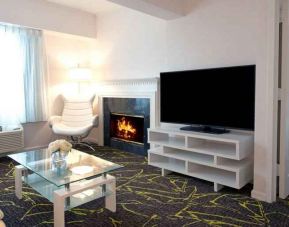 Beautiful hotel suite with fireplace at the The Roslyn, Tapestry Collection by Hilton.