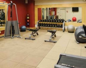 Fitness center with weights and machines at the DoubleTree by Hilton Omaha-Downtown.