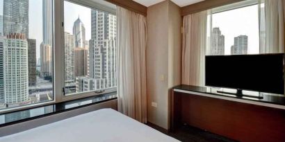 King guestroom with city view at the Embassy Suites by Hilton Chicago Magnificent Mile.