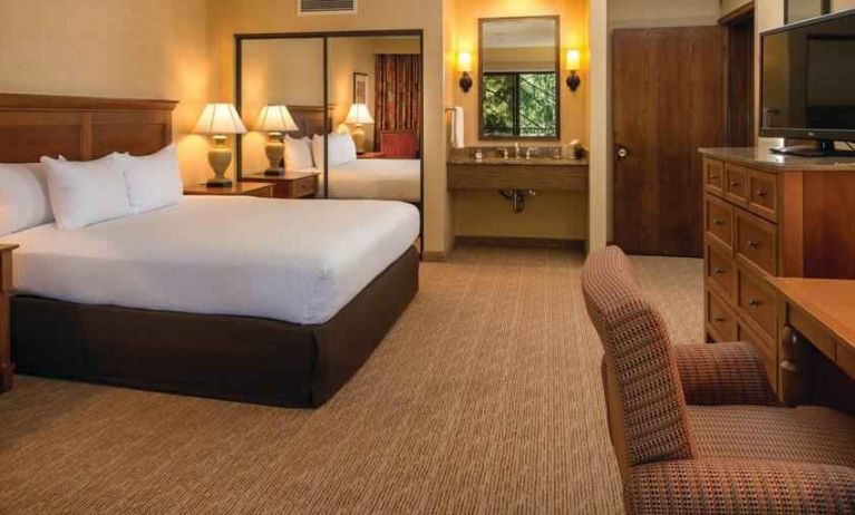 Beautiful king suite with TV screen and desk at the DoubleTree by Hilton Seattle Airport.