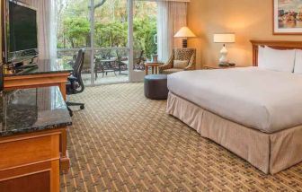 Spacious and comfortable king suite with balcony at the Hilton Seattle Airport & Conference Center.