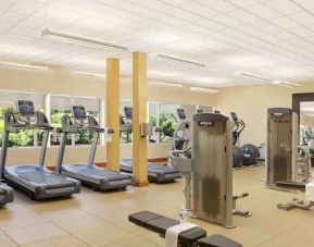 Fitness center with treadmills and machines at the Hilton Seattle Airport & Conference Center.