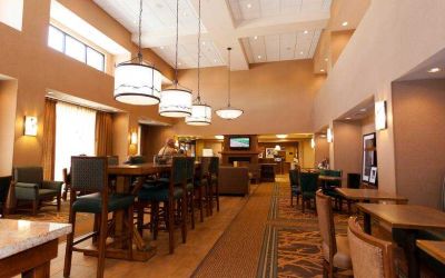 Restaurant area with chairs and tables perfect as workplace at the Hampton Inn & Suites Riverton, WY.